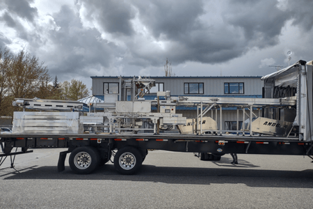 Loaded Flatbed Hauler Truck with Andgar Food Processing Equipment tied down on it